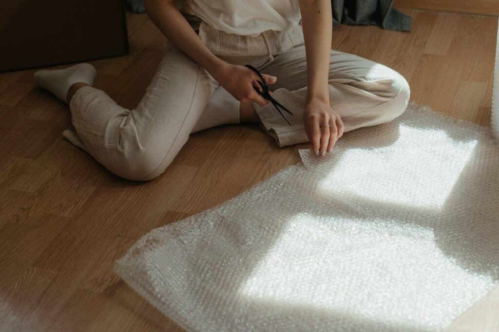 Woman cutting bubble wrap with scissors